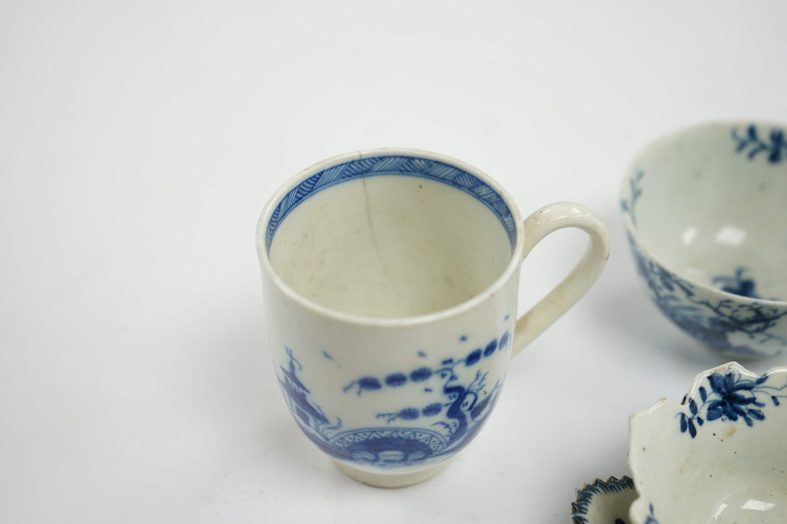 A group of first period blue and white Worcester, including a leaf cup and saucer, two tea bowls and a handled cup, leaf saucer 9.5cm wide (5). Condition - leaf cup cracked, two tea bowls good handled cup, bowl cracked